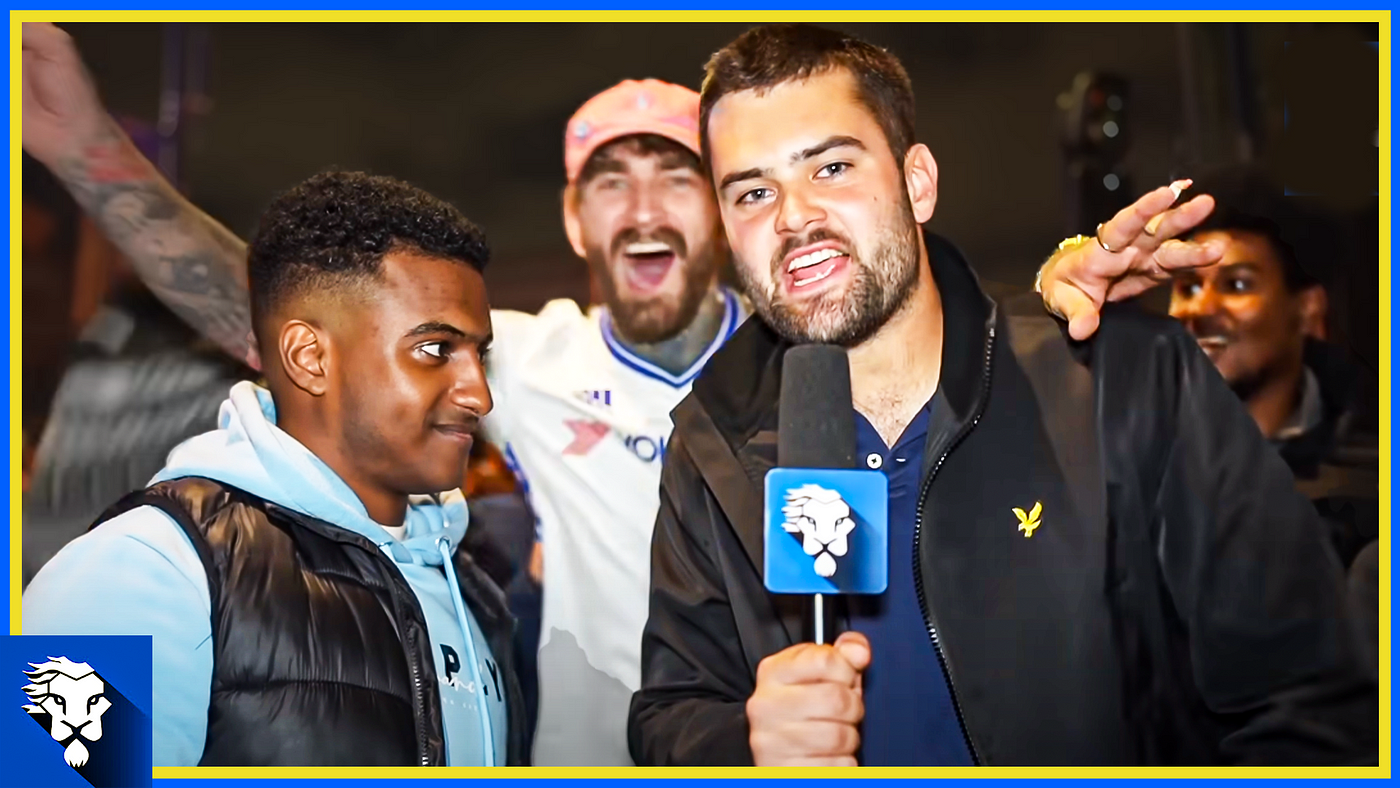 Alex Harris interviewing Chelsea fans on the mic for Chelsea Fan TV